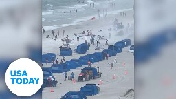 Cameras capture waterspout making ripping through crowded beach | USA TODAY