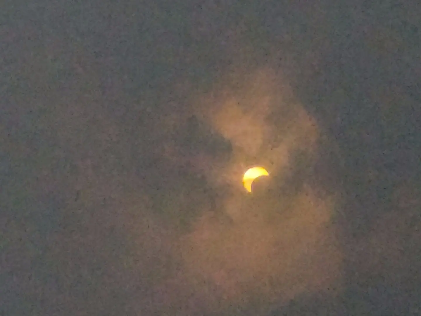 Partial solar eclipse with clouds overcovering